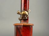 an antique lamp with a skull and crossbone on the top of it