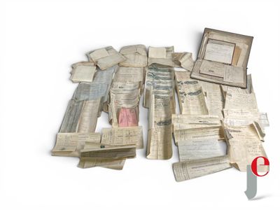 a pile of old papers and a knife on a table