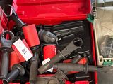 a red tool box with tools in it on the floor