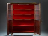 a red cabinet with a door open and shelves on the bottom