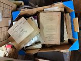 a box full of books and papers sitting on a table