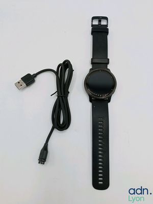 a close up of a watch with a cable connected to it