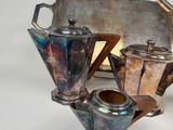 a silver tray with a silver tea pot and a silver tray with a silver tea pot and a silver tray with a silver tea pot and a silver tray