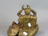 a bronze statue of a man on a motorcycle