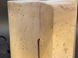 pair of concrete lamps with a white shade on a black table