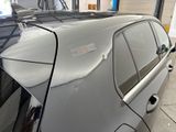 a car that is parked in a garage with its door open