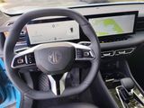 the interior of a car with a steering wheel, dashboard, and dash board
