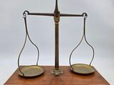 a brass scale with two scales on top of it