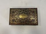 an old brass cigarette case sitting on top of a white table