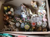 a box full of assorted figurines in it