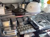 many pans and pans on the counter in the kitchen