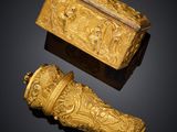 pair of gold - plated boxes and a box with figures on it