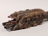 an image of a sculpture of a hand holding a piece of wood