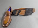 pair of men ' s brown leather shoes on a grey surface