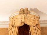two birds sitting on top of a bed in a room