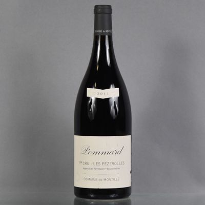 a bottle of wine sitting on top of a table next to a glass