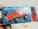 a person holding a box with a toy car on it