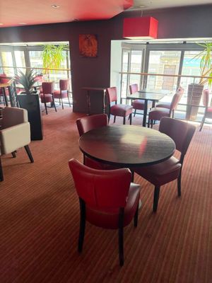 many chairs and tables in this restaurant with a large window