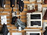 many bags and bags hanging on a wall in a store