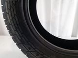 a close up of a tire on a white surface