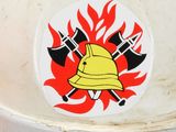 a fire hydrant with a fire helmet and axes on it