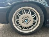 a close up of a black car with a silver rim