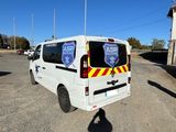 a white van parked in a parking lot with a shadow on the ground