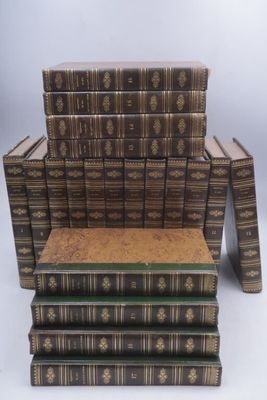 several books stacked on top of each other on a white surface