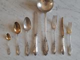 a lot of silver spoons and spoons on a table