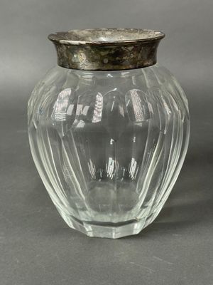 an image of a glass jar with a silver lid on a gray surface