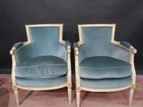 pair of blue velvet armchairs with gold trim