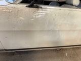 a white car with a broken door and a broken window
