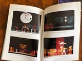 a book with pictures of dancers on it on a table