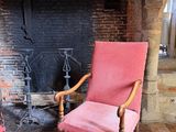 two chairs that are sitting in front of a fire place