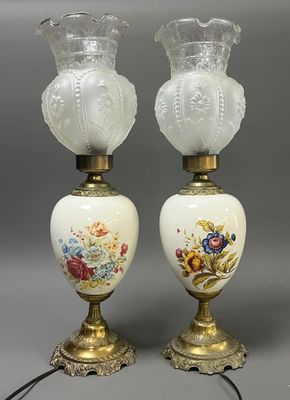 pair of antique glass lamps with gold trim and floral designs