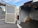 a white van with the door open and a dog sleeping in the back