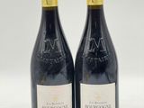 deux bouteilles de vin posées l'une à côté de l'autre sur une table