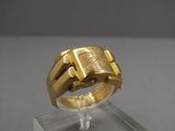an image of a gold ring sitting on top of a clear stand