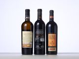 three bottles of wine are lined up on a table