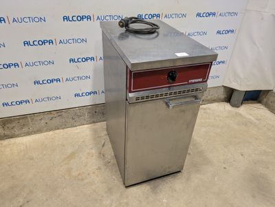 a silver refrigerator sitting on top of a floor next to a wall