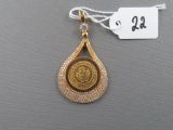 an image of a gold pendant with a coin on it