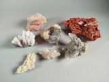 several different types of rocks and crystals on a white surface