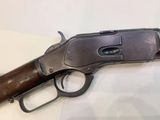 a close up of a gun on a table with a white background
