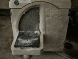 a dirty toilet in a dirty room with a price tag on it