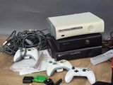 several video game consoles and controllers sitting on a wooden floor