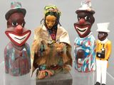 trois figurines représentant différentes personnes sont exposées