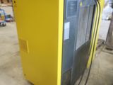 a yellow refrigerator that is sitting in a warehouse