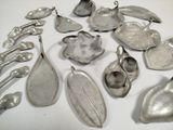 a lot of silver spoons and spoons on a table