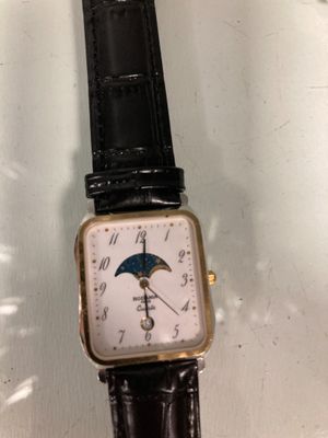 a watch that is sitting on a glass table