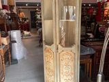 a tall wooden cabinet in the middle of a room